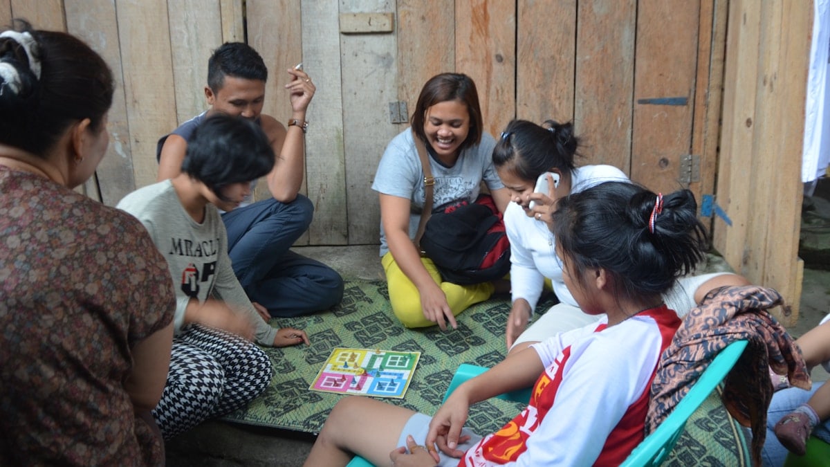 Group of people in rural Indonesia playing a game.